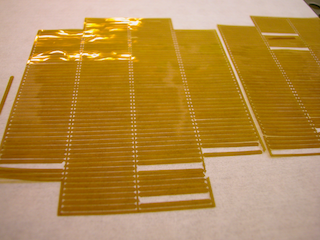 Small Polymer nozzle-plates, micropatterned conical spray orifices